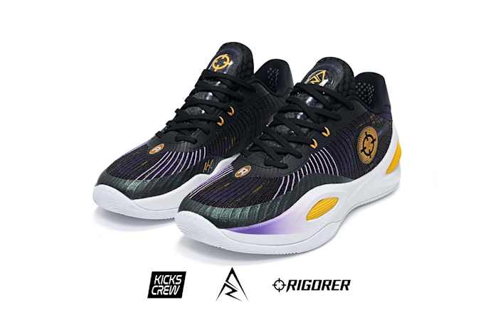 Side view of Austin Reaves' black, white, and gold sneakers.